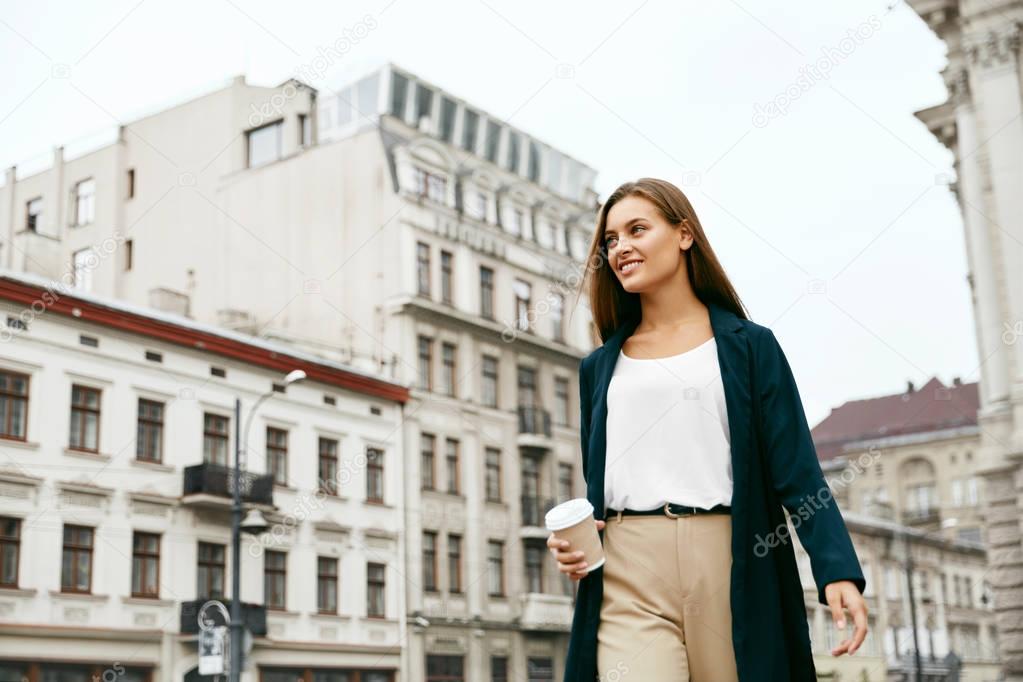 Beautiful Business Woman With Drink On Go Walking On Street.