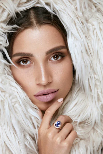 Beauty Makeup. Woman Face With Beautiful Facial Skin In Fur