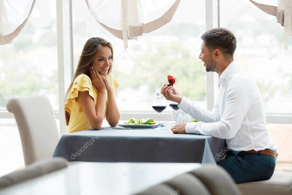 Proposal In Restaurant. Man Proposing Woman