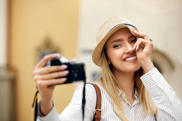 Schönes glückliches Mädchen, das Fotos vor der Kamera macht. — Stockfoto