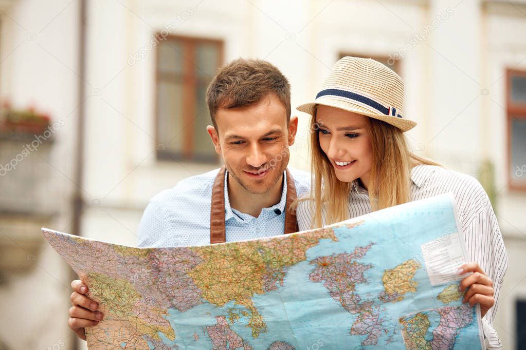 Travel. Tourist Couple With Map On Street