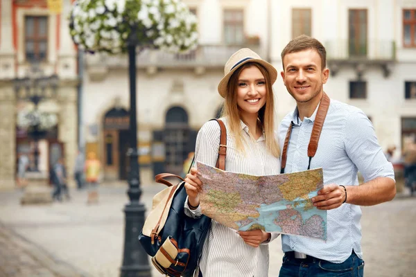 Turistické pár s mapou chůzi na ulici města. — Stock fotografie