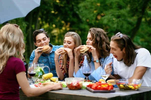 People Eating Healthy Food On Outdoor Party. Friends