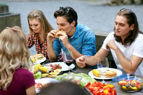 People Eating Healthy Food On Outdoor Party. Friends