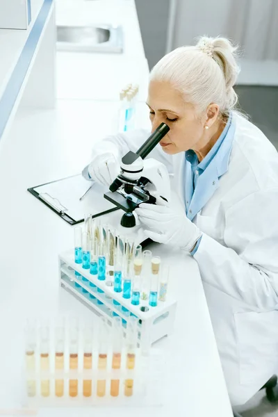Laboratory Research. Woman Looking Through Microscope.