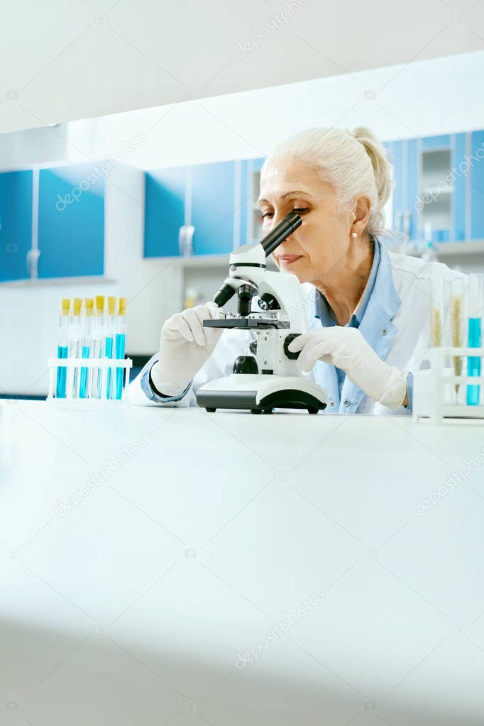 Laboratory Research. Woman Looking Through Microscope.