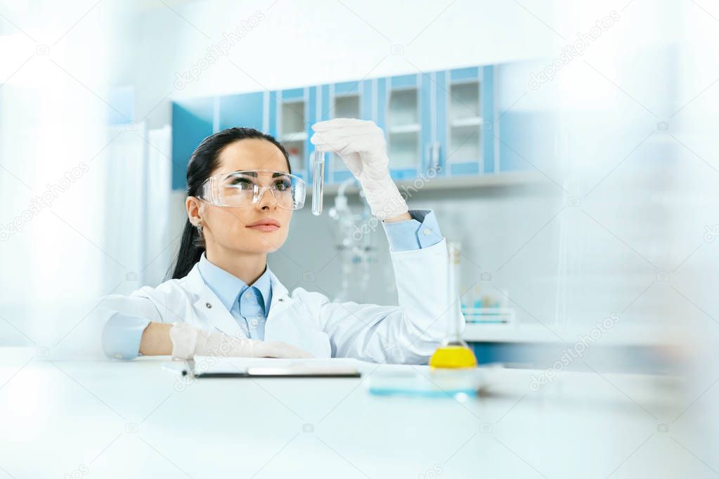 Scientific Laboratory. Female Scientist With Laboratory Glass.