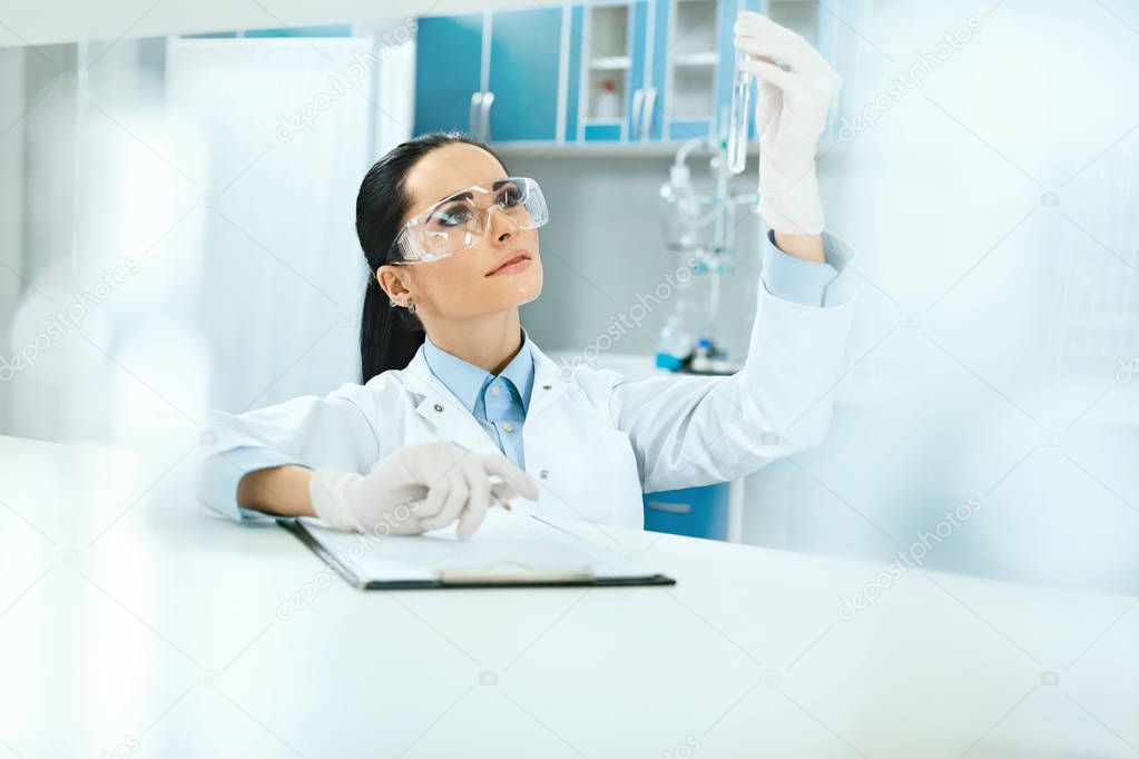Scientific Laboratory. Female Scientist With Laboratory Glass.