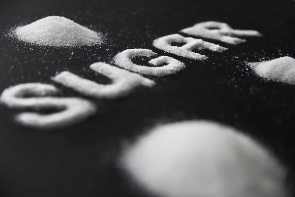 Slovo cukr. Bílý cukr na pozadí — Stock fotografie