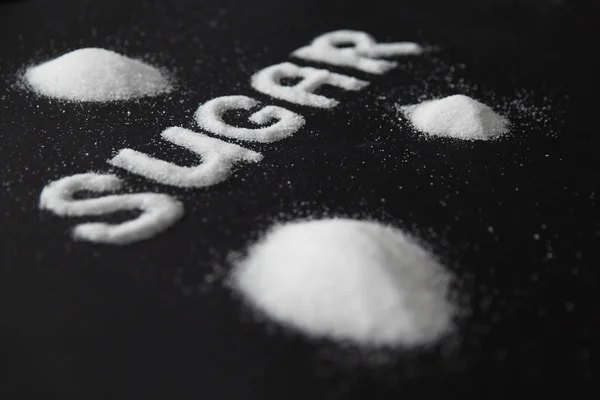 Zuckerwort. weißer Zucker auf Hintergrund — Stockfoto