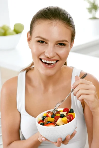 Zdrowe jedzenie. Szczęśliwa kobieta jedzenie Sałatka z owoców. — Zdjęcie stockowe