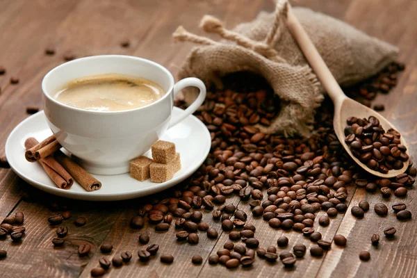 Uma chávena de café. Bebida quente e feijão na mesa . — Fotografia de Stock