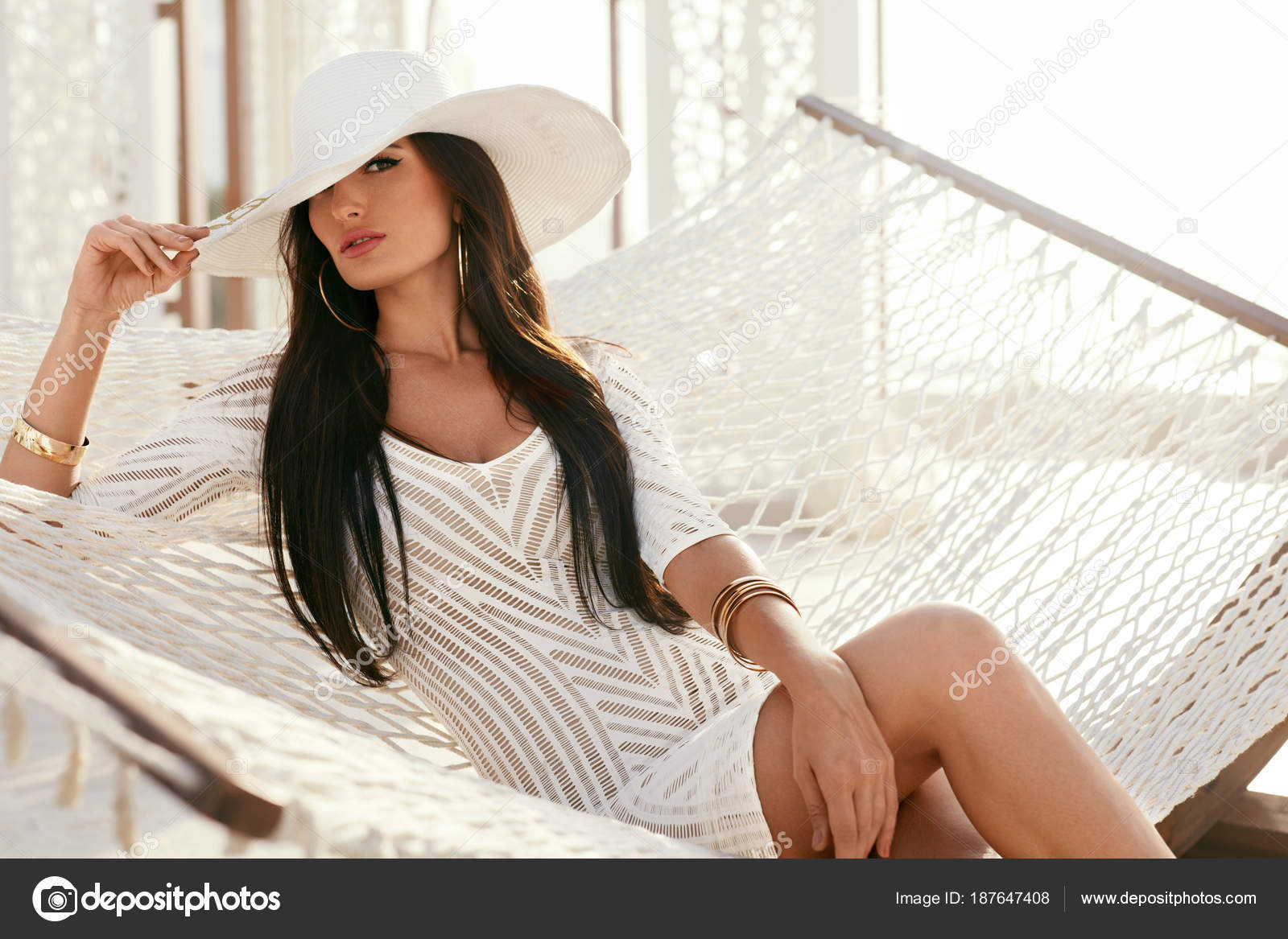 Fashion Girl In Elegant White Hat And Fashionable Clothes Stock Photo by  ©puhhha 187647408