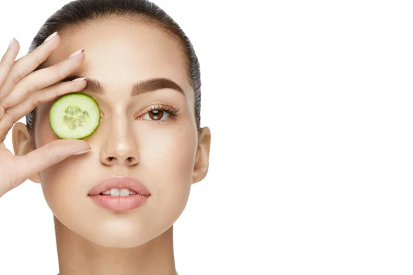 Cuidados com a pele. Mulher com maquiagem natural usando pepino — Fotografia de Stock