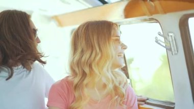 Arkadaşlar arabaya yaz aylarında seyahat, eğleniyor. Yaz seyahat zevk mutlu gülümseyen genç arkadaşlar. Yakışıklı ve güzel kadının Retro otobüs ve yaz tatili.