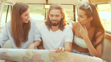 Yaz aylarında seyahat etmek harita kullanan kişiler. Haritayı kullanarak, hafta sonu gezisi güneşli günde zevk mutlu genç arkadaşlar gülümseyerek. Adam ve kadın arabada eğleniyor. Seyahat ve Turizm.