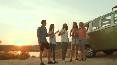 İnsanlar içme. Mutlu arkadaşının doğada eğlenceli zevk partisi. Bir grup genç insan gülüyor, kutlama ve hafta sonu yaz aylarında seyahat içecekler, tezahürat.