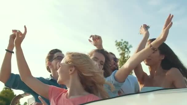 夏の旅行 お友達と楽しんで オープンカーで移動します 若い男性と美しい女性の開いた屋根が付いている車で旅行を笑顔の旅行を楽しむ 風のダンス 冒険を探して — ストック動画