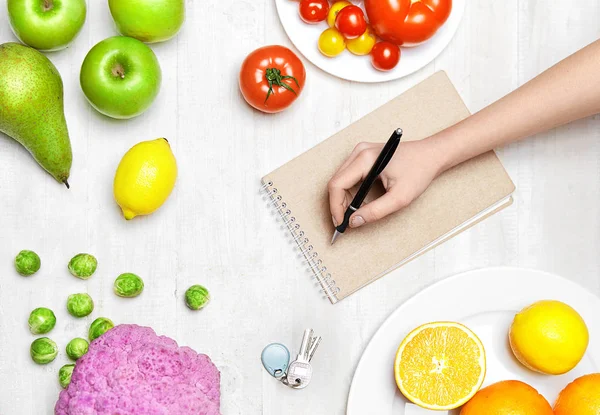 Healthy Food. Woman Hand Writing Diet Plan