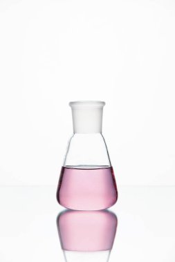 Laboratuar kapkacakları. Beyaz arka plan üzerinde pembe sıvı ile cam