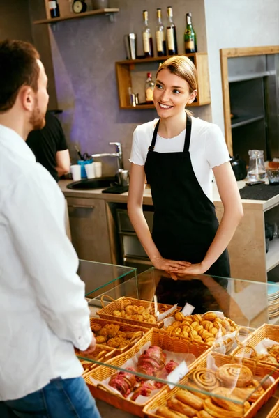Bageriet. Kvinnan arbetar, sälja bageriet till hane — Stockfoto