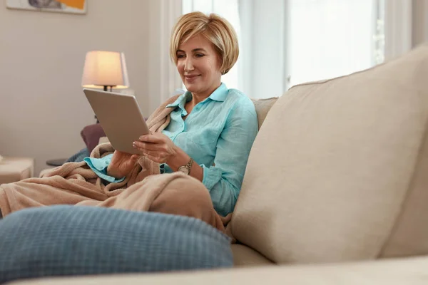 Perempuan Dengan Tablet Mature Woman Sofa Beige Plaid Menggunakan Perangkat — Stok Foto