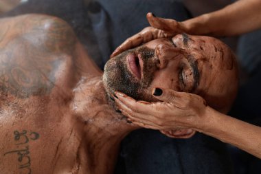 Spa masajı. Erkek için Cilt Bakımı Tedavisi. Çamurlu Güzellik Masajcısı. Doğal Kozmetik Prosedürü Üzerine Gevşek Model.
