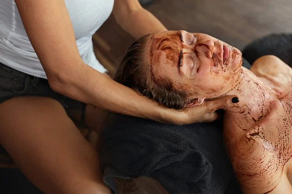 Skin Care. Beautician Applying Face Mask During Beauty Treatment For Relaxed Woman. Spa Procedure Concept.