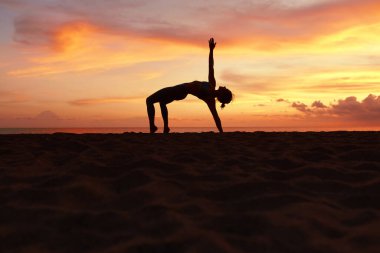 Yoga Poses. Woman Practicing Half Moon Asana On Ocean Beach. Female Silhouette Standing In Ardha Chandrasana At Beautiful Sunset. Yoga As Exercise For Lifestyle. clipart