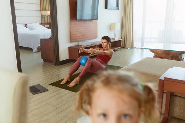 Home Workout. Social Isolation For Staying Active And Fit. Mother Doing Exercise, Daughter Taking Selfie On Smartphone. Young Woman Practicing In Living Room During Quarantine.