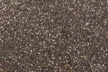 Chia tohumları. Chia tohumlarının arka planı. Dağınık Chia tohumları