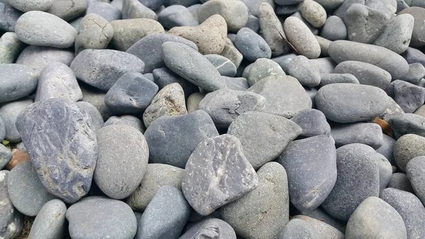 テクスチャの背景:岩の小石、小さな、丸みを帯びた、滑らかなピブル — ストック写真