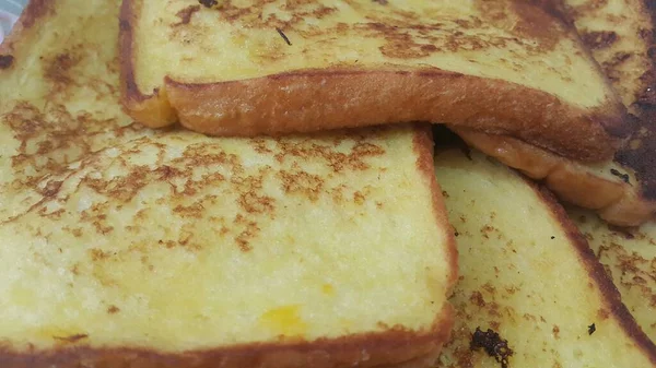 Closeup view of freshly prepared half fried slices of toast bread — Stock Photo, Image