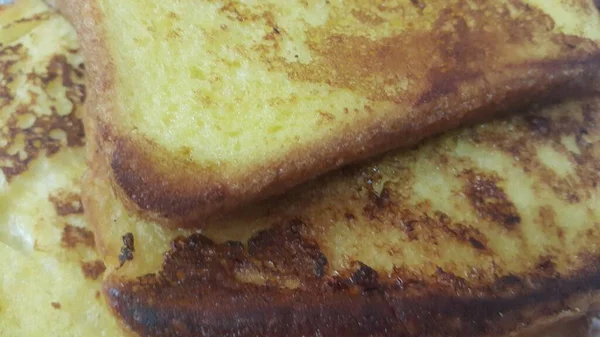 Closeup view of freshly prepared half fried slices of toast bread — Stock Photo, Image