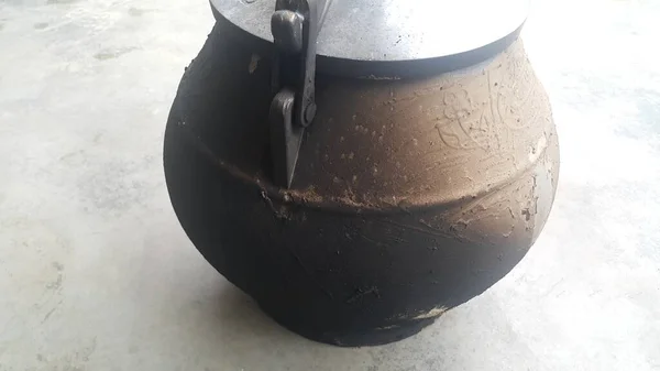 Cauldron type rural pressure cooker covered with mud