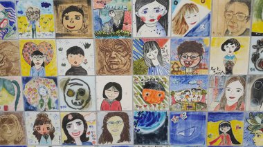 Anılar için duvardaki insanların resimleri ve heykel yüzleri.