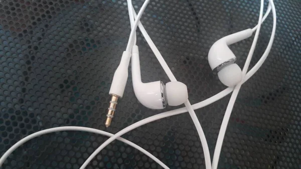 White headphones with headset lying on black background — Stock Photo, Image