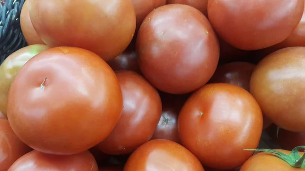 Red tomatoes in red basket in market for sale — Stock Photo, Image