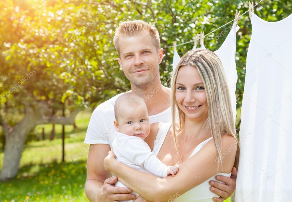 Happy family with a baby outdoors