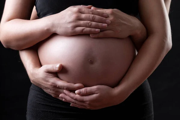 Portrait of parents holding a pregnant belly — Stock Photo, Image