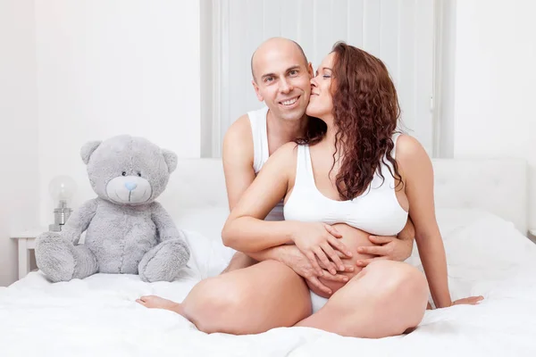 Delighted young parents in bed expecting a baby — Stock Photo, Image