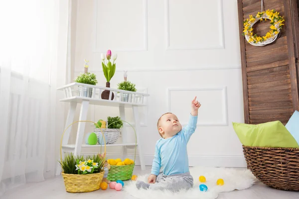 Easter egg hunt. Adorable child playing with Easter eggs at home