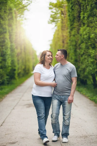 Happy loving couple on a romantic walk outdoors in park — Stock Photo, Image