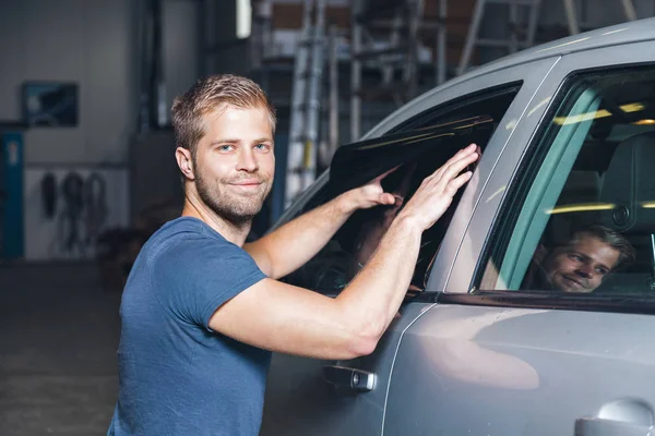 Applying tinting foil onto a car window — Stock Photo, Image