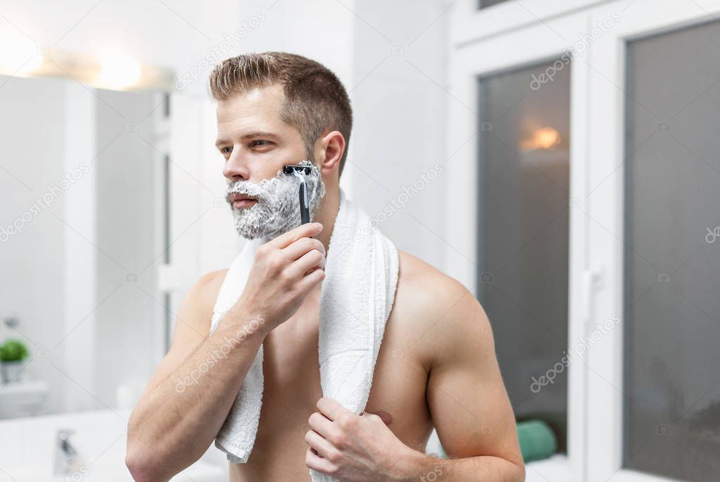 Morning hygiene, Man in the bathroom looking in mirror