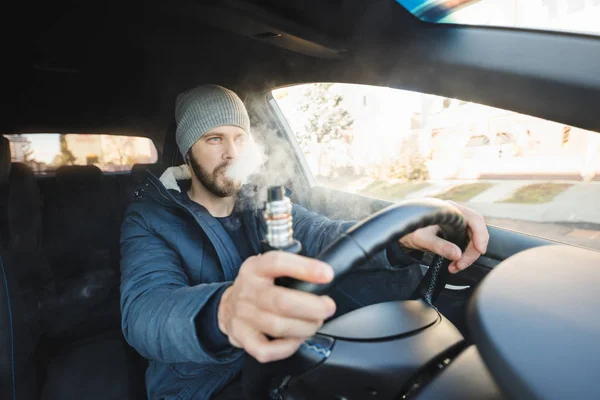 Vaping um cigarro eletrônico enquanto dirige no carro — Fotografia de Stock