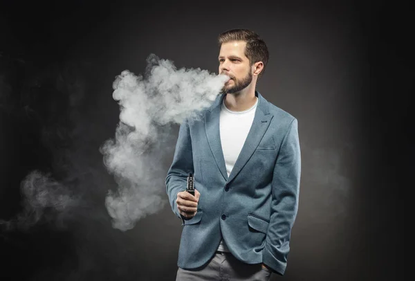 Vaping e-liquid from an electronic cigarette — ストック写真