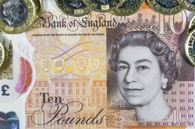 Londra, İngiltere: 03 Ocak 2017: İngiliz bir İngiliz Lirası paralar on Lirası Not arka planı yatay bir biçimde ile. Sikke ve Not sahtecilik caydırmak için tasarlanmış yeni bir sorun vardır. Not polimer ve su geçirmez değil