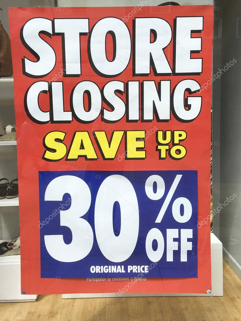 Store Closing Sign in a shop window - All Stock Reduced