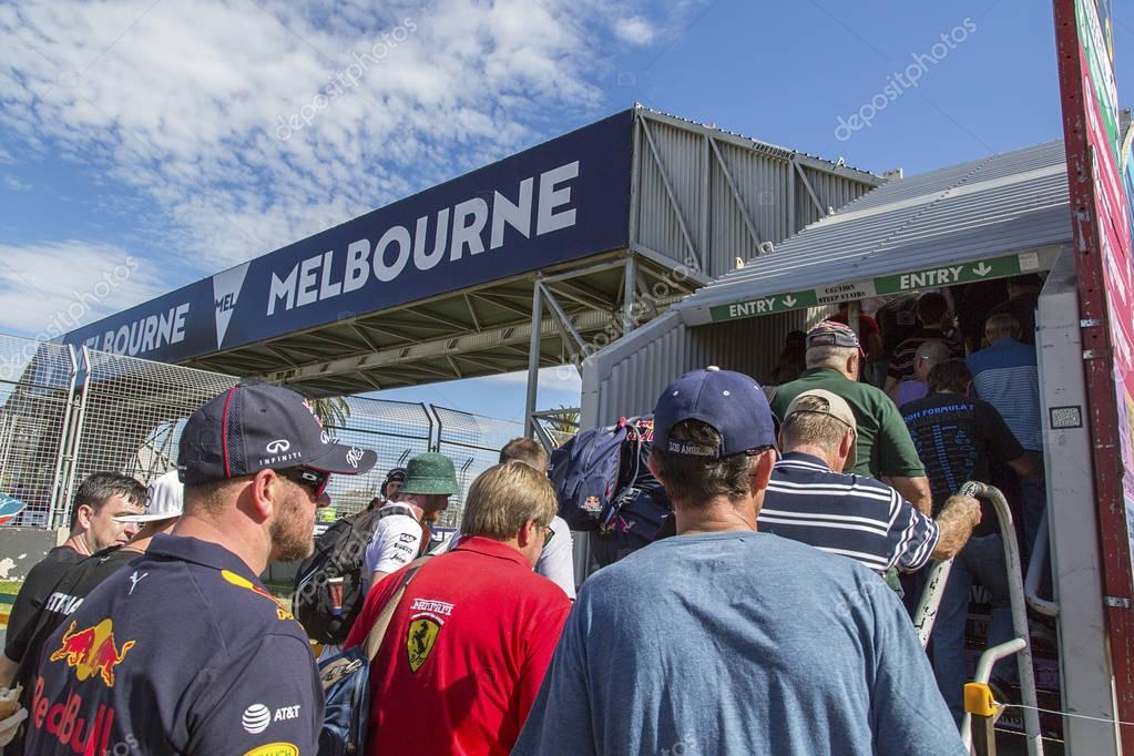 Melbourne, Australia: March 25, 2017: A large crowd of people make their way to see the Formula One event in Melbourne. The bridge enables the spectators to safely cross the race track